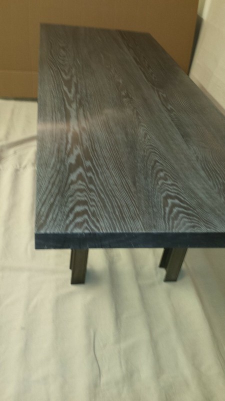 dining table of acid ebonized/limed white oak and hot rolled steel