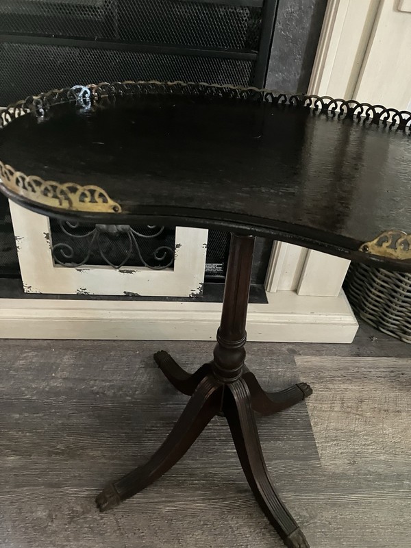 This is a Ferguson Bros coffee table made of mahogany in a kidney shape ,