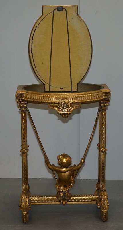 CIRCA 1920 GOLD GILTWOOD OCCASIONAL TABLE WITH MIRROR TOP & CHERUB PUTTI SWING gallery