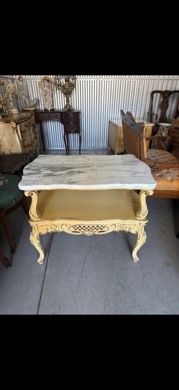 French Provincial style coffee table with marble top and carved wood base