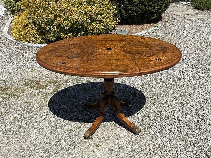 English Regency tilt top oval breakfast dining table Book matched burl walnut