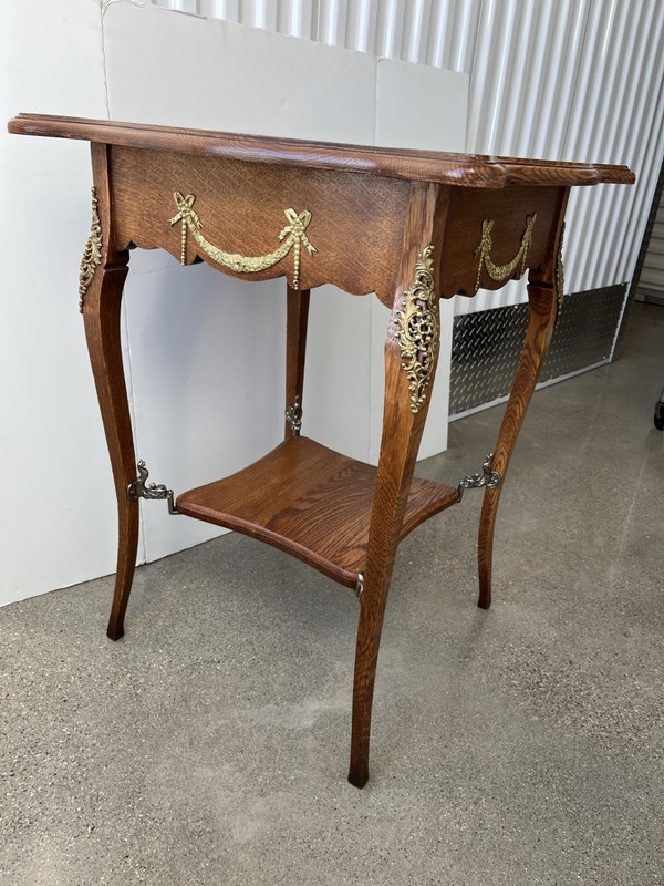 Antique French Louis XV oak accent table with shelf, ormolu and dolphin mounts