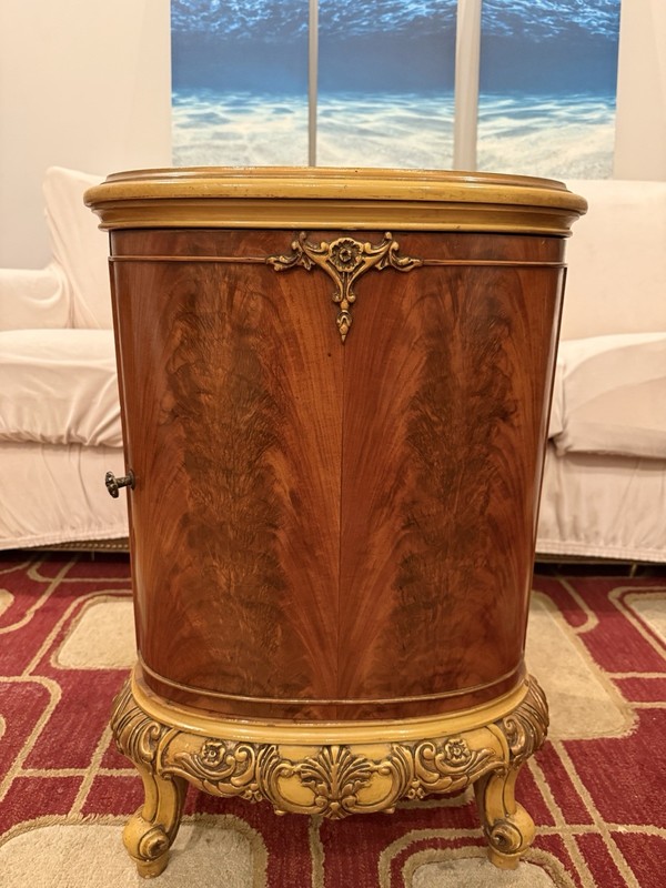 French Provincial Louis XV style flame mahogany nightstand with gilt accents.