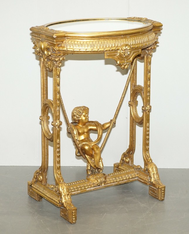 CIRCA 1920 GOLD GILTWOOD OCCASIONAL TABLE WITH MIRROR TOP & CHERUB PUTTI SWING gallery