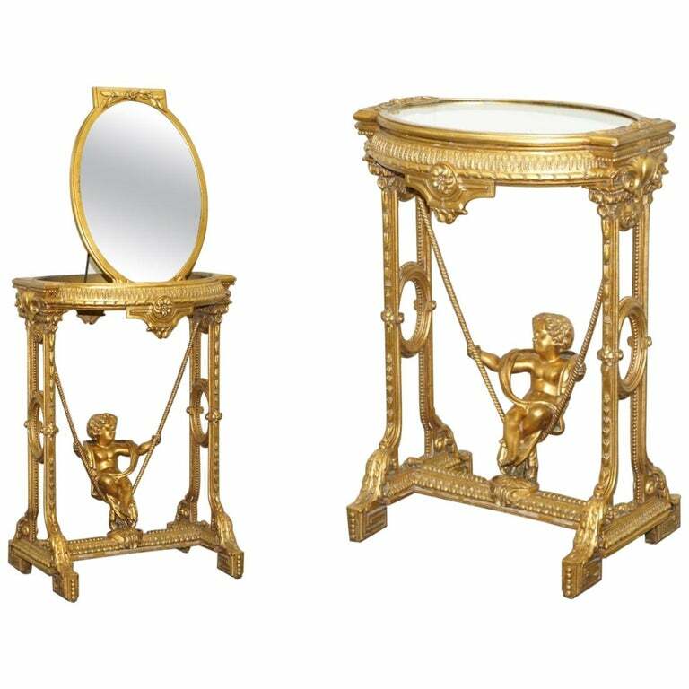 CIRCA 1920 GOLD GILTWOOD OCCASIONAL TABLE WITH MIRROR TOP & CHERUB PUTTI SWING