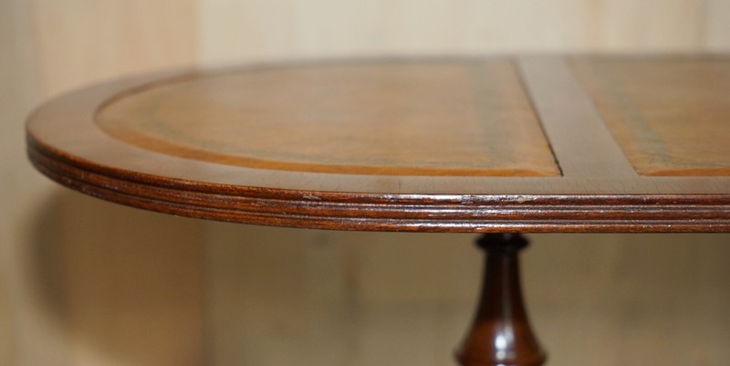 VINTAGE HAND DYED AND AGED BROWN LEATHER OVAL COFFEE TABLE WITH LION CASTORS gallery