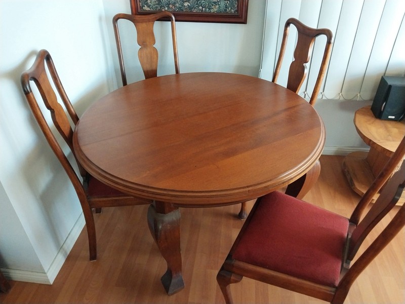 Round Oak Dining Table with Four Upholstered Chairs