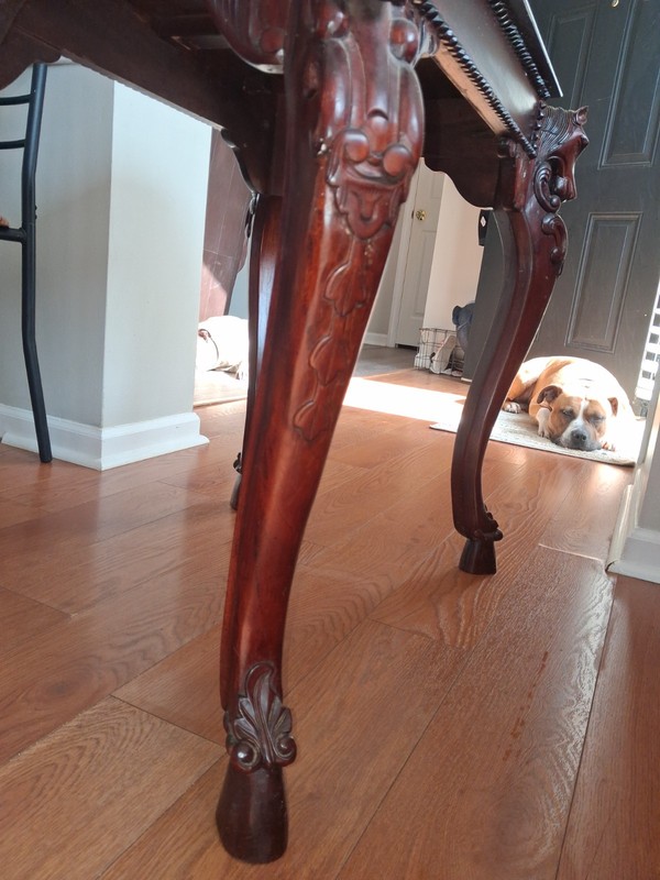 Hand-carved mahogany side table featuring horse head details and hoofed feet. gallery