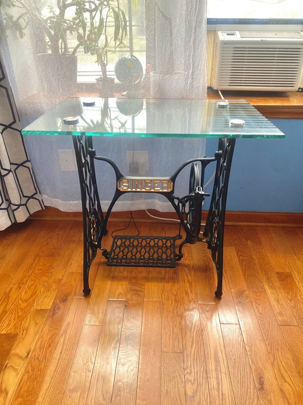Singer modified table with glass top.