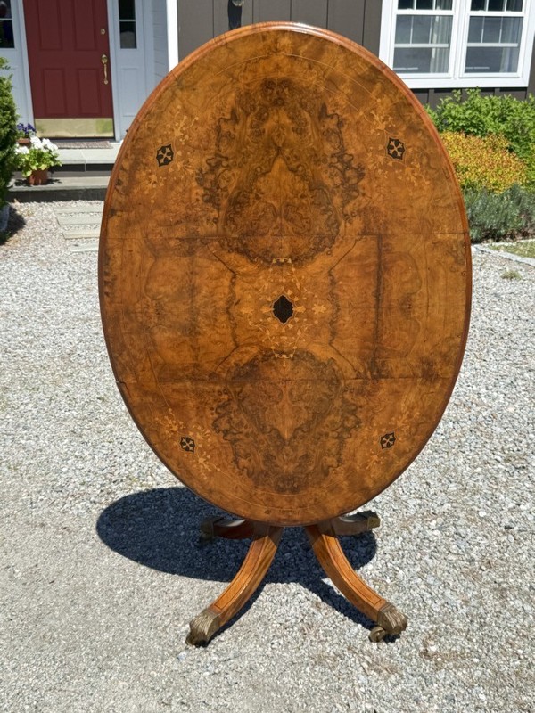 English Regency tilt top oval breakfast dining table Book matched burl walnut gallery