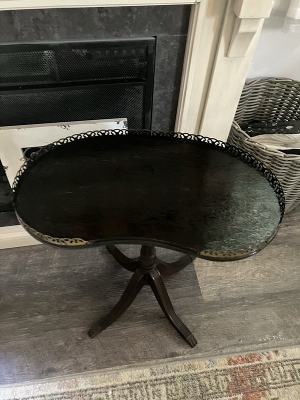 This is a Ferguson Bros coffee table made of mahogany in a kidney shape , gallery