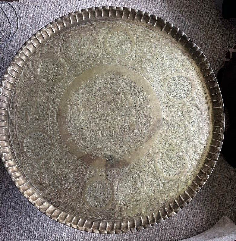 Saudi 36″ diameter brass table top with wooden folding base.