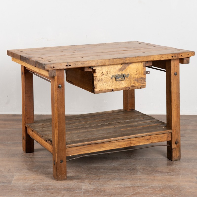 This early 20th-century Hungarian pine work table features a rustic, utilitarian