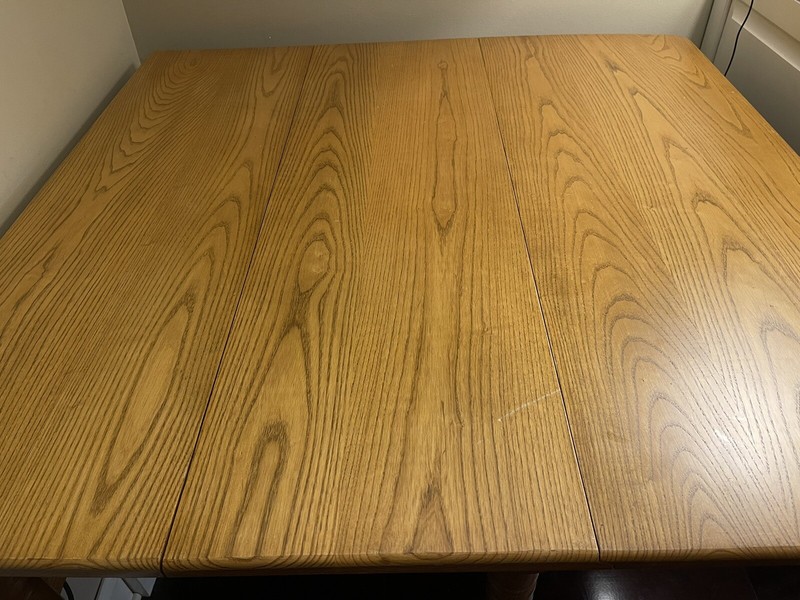 Amish made dropleaf table. Solid Oak. 27”-133” Four slatback chairs.6-12” leaves
