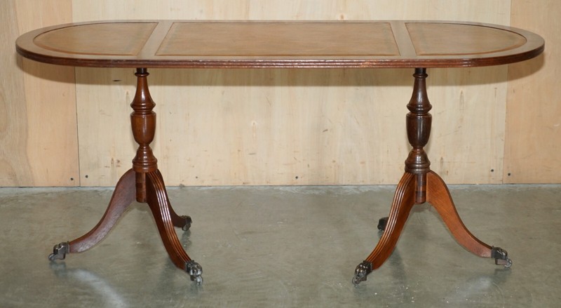 VINTAGE HAND DYED AND AGED BROWN LEATHER OVAL COFFEE TABLE WITH LION CASTORS gallery
